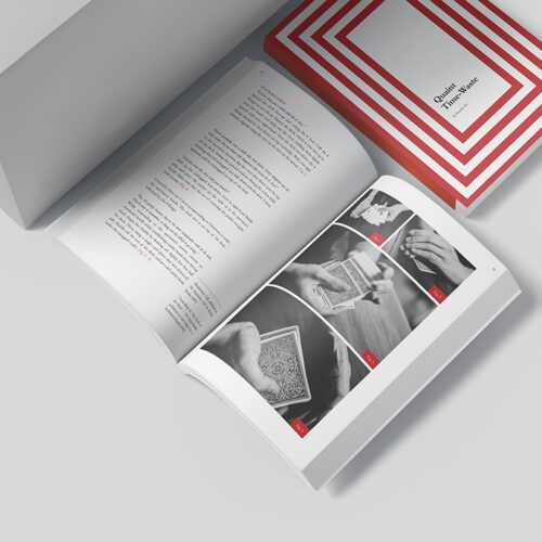 Open book showing black-and-white photos of card handling with a red-and-white striped box nearby, in a clean studio setup.
