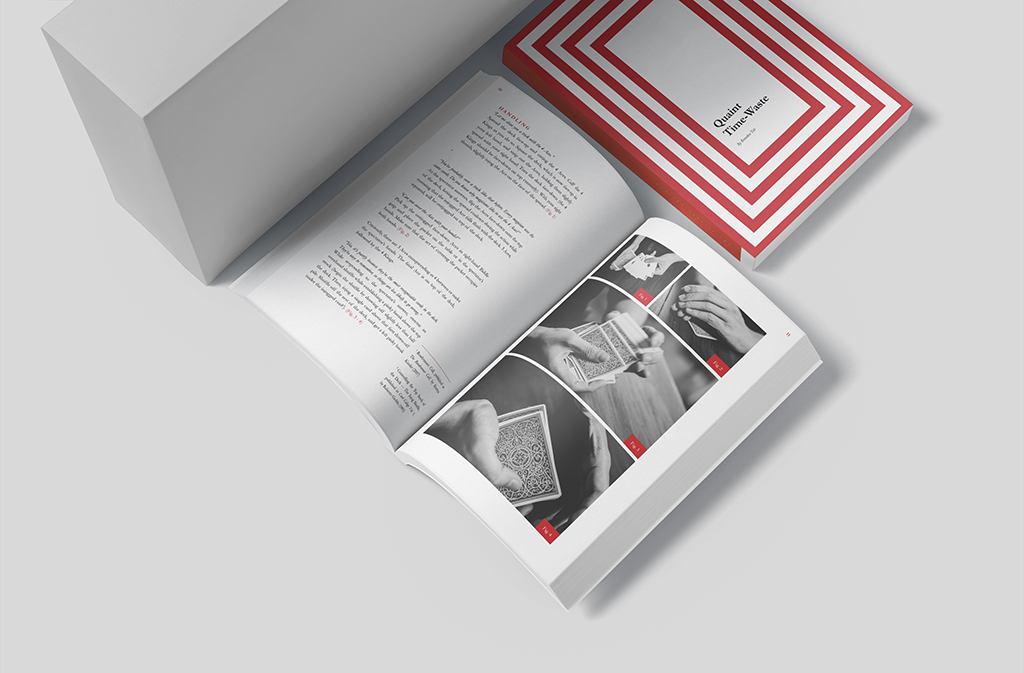 Open book showing black-and-white photos of card handling with a red-and-white striped box nearby, in a clean studio setup.